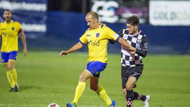 Gold Coast Premier League football (soccer) grand final between Gold Coast Knights and Broadbeach United from at Croatian Sports Centre, Carrara, on Saturday. Gold Coast Knights player, Roman Hofmann and Broadbeach United player Russell Miner. Picture: Jerad Williams