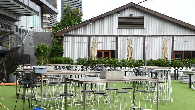 Empty table and chairs are seen as restaurants close their businesses on Monday. Picture: Quinn Rooney/Getty Images