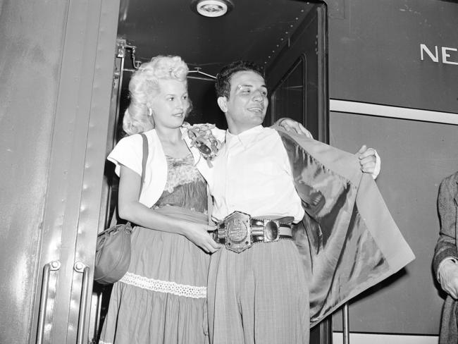 Newly crowned World Middleweight Boxing Champion Jake LaMotta, with his wife Vicky, arrives at Grand Central Terminal in New York after defeating Marcel Cerdan in Detroit on June 16, 1949. Picture: AP