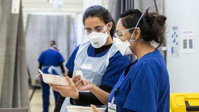 Medical staff at the Melbourne Showgrounds Covid-19 vaccine hub on Monday. Picture: Aaron Francis