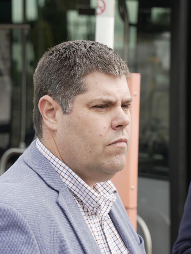 Queensland transport minister Brent Mickelberg outside a Bus Queensland bus on Kitchener Street in East Toowoomba.