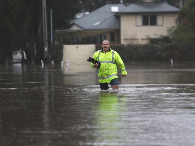 Hugh Pennell pictured during the height of the flooding at Chittaway Bay. Picture: Sue Graham