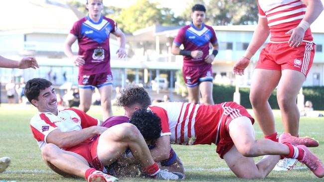 Dylan Watkins (left) and Riley Loughland (right) make a trysaver in Palm Beach Currumbin SHS's round six clash against Wavell SHS.