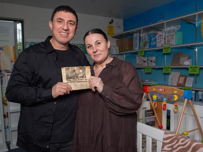 Nick and Trish Dellas the owners of store Baby2Kids at Rosny Park  are closing down after 21 years.  They are holding a story from The Mercury from when they first opened.  Picture: Linda Higginson