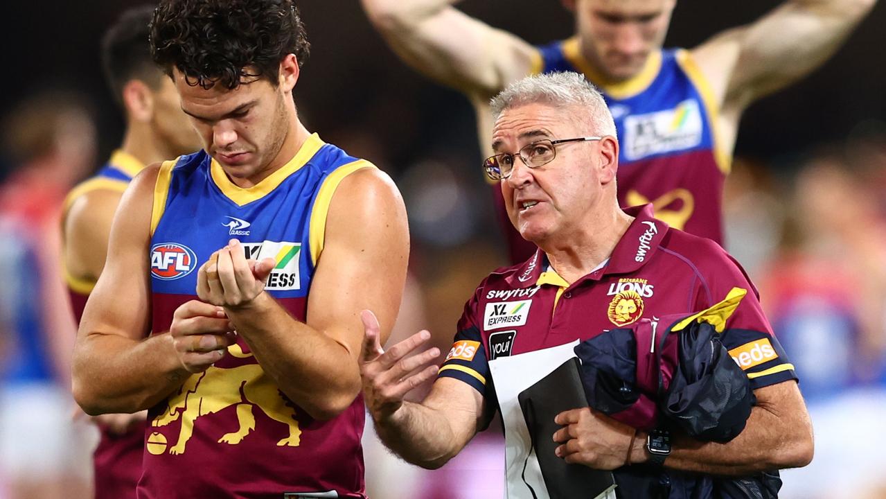 BRISBANE, AUSTRALIA - AUGUST 19: Lions coach Chris Fagan and Cam Rayner leave the field after losing the round 23 AFL match between the Brisbane Lions and the Melbourne Demons at The Gabba on August 19, 2022 in Brisbane, Australia. (Photo by Chris Hyde/Getty Images)