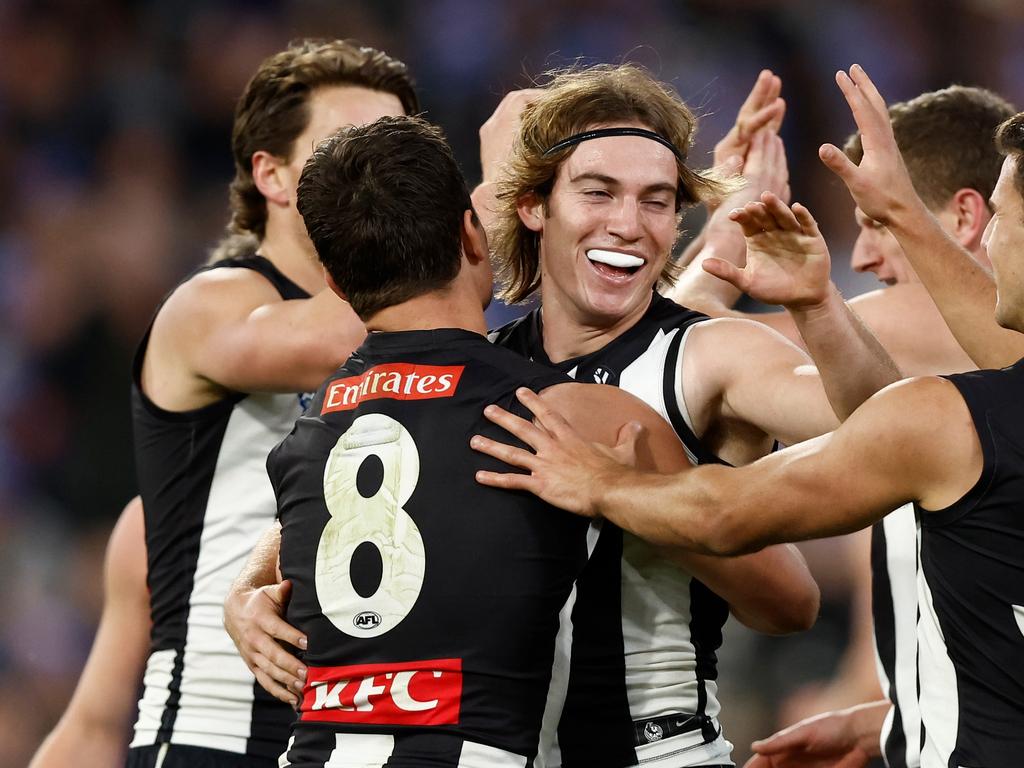 MELBOURNE, AUSTRALIA - JUNE 10: Harvey Harrison of the Magpies celebrates a goal with teammates during the 2024 AFL Round 13 match between the Collingwood Magpies and the Melbourne Demons at The Melbourne Cricket Ground on June 10, 2024 in Melbourne, Australia. (Photo by Michael Willson/AFL Photos via Getty Images)