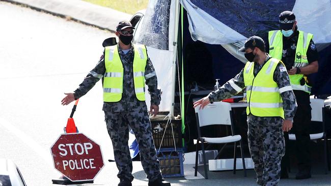 Police and the ADF at the Queensland border on the Gold Coast Highway in Coolangatta. Picture: NIGEL HALLETT