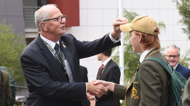 A quick hair check. Deputy Headmaster Rohan Brown returns to Trinity Grammar and is greet by students and parents at the start of term. Picture: Tony Gough