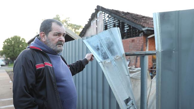 Ken Roberts out the front of his gutted home. The fire is believed to have started in the carport before spreading to the roof space. Picture: Dean Martin