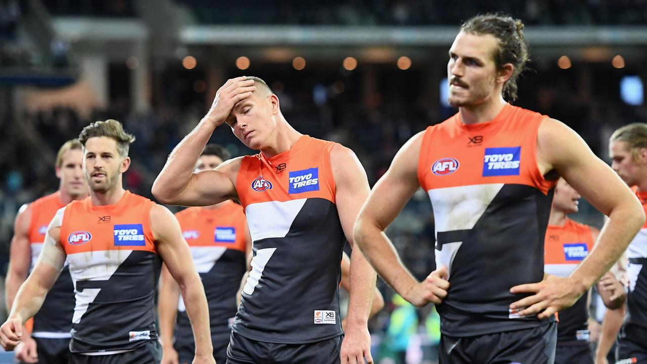 Callan Ward, Adam Tomlinson and Phil Davis of the Giants look dejected after losing to Geelong.
