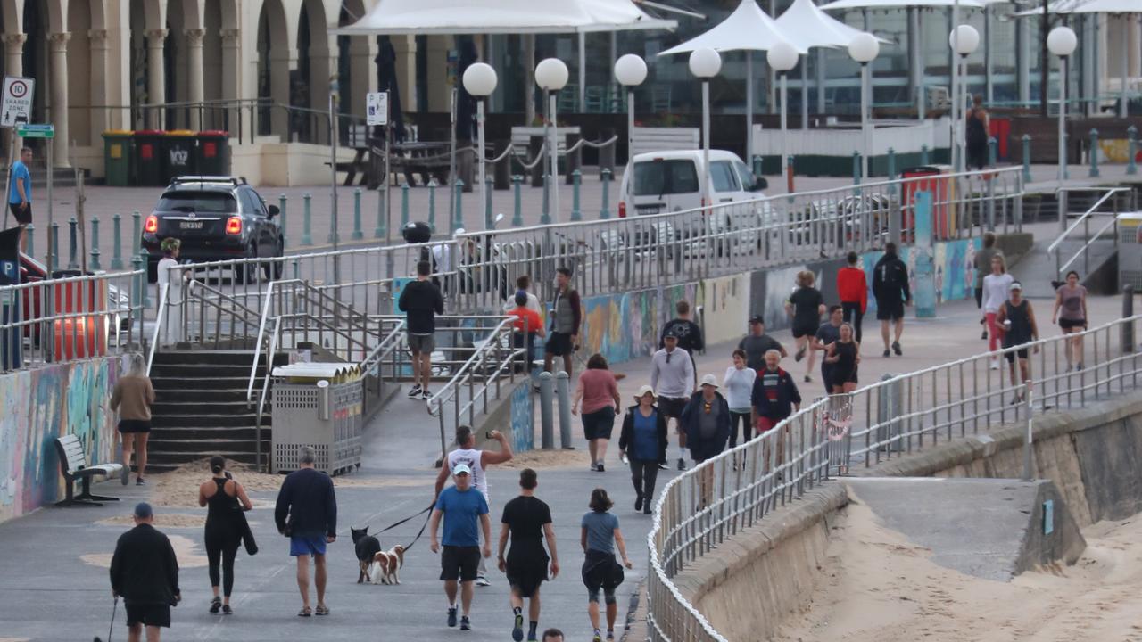 People enjoying the Bondi esplanade on Friday morning. Picture: John Grainger