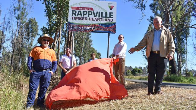 Bold new signs for Rappville.Pictured is designer Ian Thompson, Richmond Valley mayor Robert Mustow, Rappville resident Barbara Collins, Lismore City Council mayor Isaac Smith and Pastor Peter Boughey from Toys Change Lives where indigenous artist Lenny Hickling works. (he painted the painting at the bottom of the sign.)