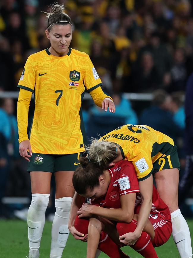 Ellie Carpenter consoles Denmark's forward Signe Bruun. (Photo by STEVE CHRISTO / AFP)