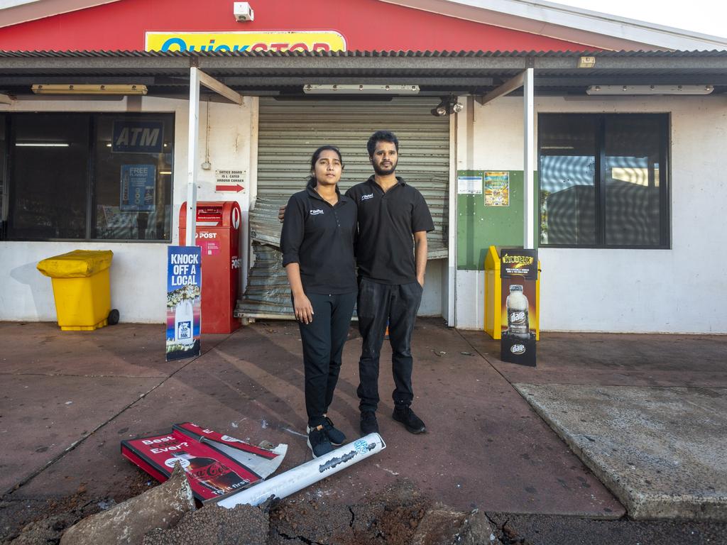 United Petroleum Noonamah owners Apoorva Chilukuri and Ram Kolan stand in front of their destroyed shop from which will cost thousands to replace. Picture: Floss Adams.