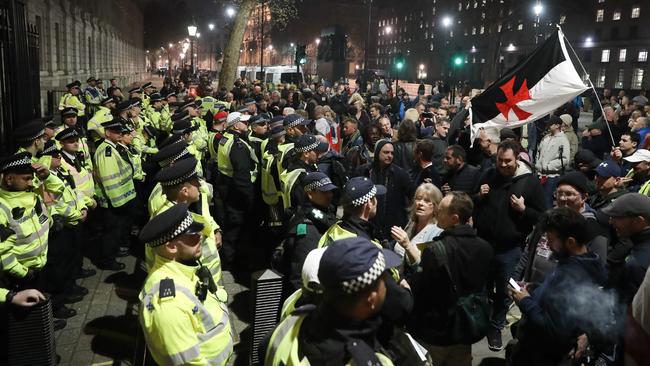 Pro-Brexit supporters face police officers  securing the gates of Downing Street after MPs rejected Theresa May’s Brexit plan for a third time.