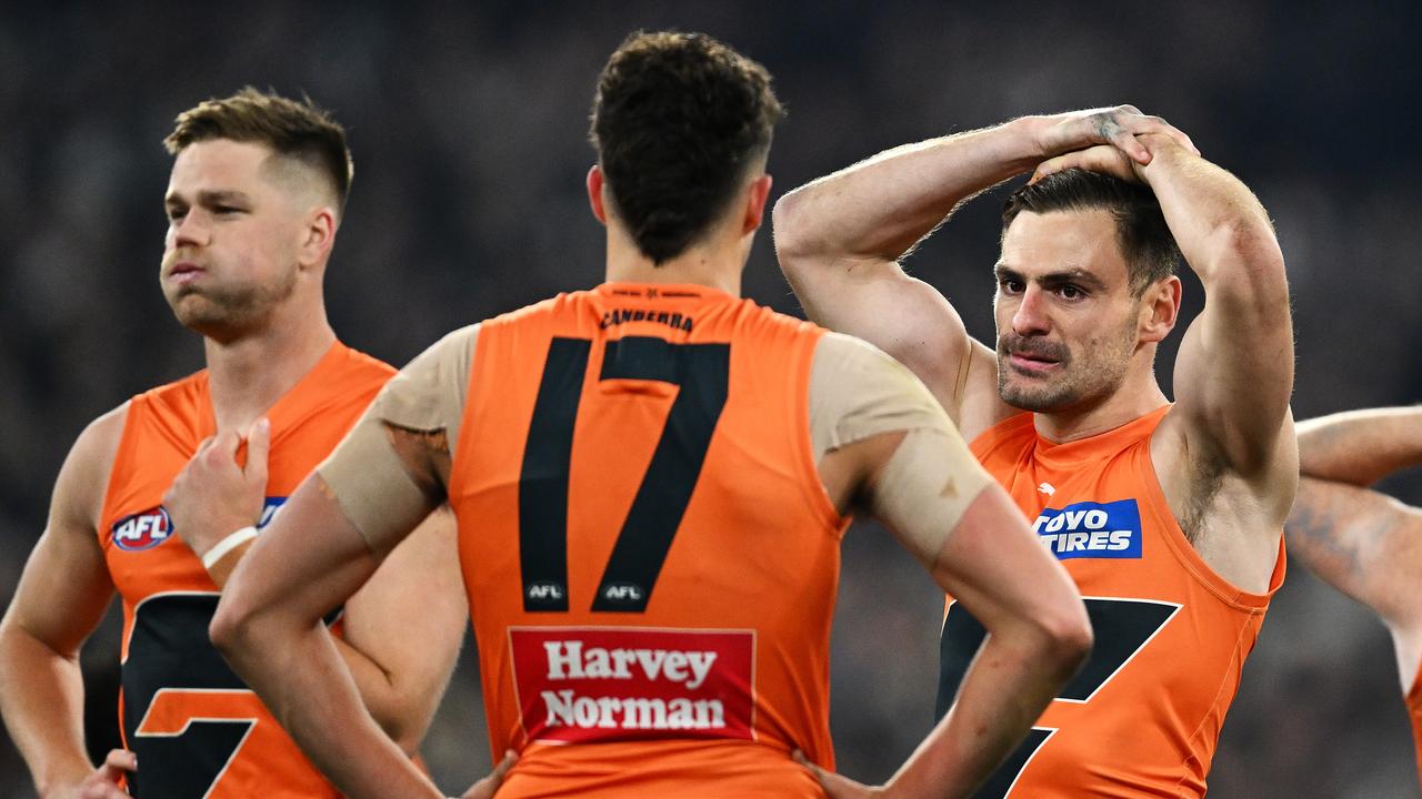 MELBOURNE, AUSTRALIA - SEPTEMBER 22: Harry Himmelberg, Finn Callaghan and Stephen Coniglio of the Giants look dejected after defeat during the AFL First Preliminary Final match between Collingwood Magpies and Greater Western Sydney Giants at Melbourne Cricket Ground, on September 22, 2023, in Melbourne, Australia. (Photo by Quinn Rooney/Getty Images)