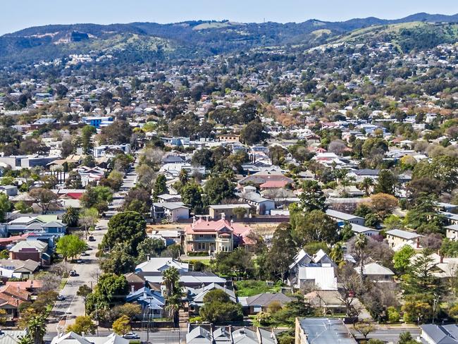 Aerial view of sprawling leafy eastern suburbs of Adelaide with Mt Lofty Ranges in the background