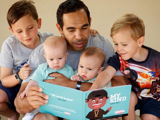 Eddie Betts with his children Lewis, 5, twins Alice and Maggie, seven months with Billy, 3, reading his new children's book. Picture: Matt Turner