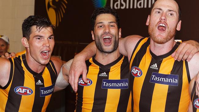 Jaeger O’Meara celebrates Hawthorn’s win over Melbourne with David Mirra and Jarryd Roughead. Picture: Getty Images