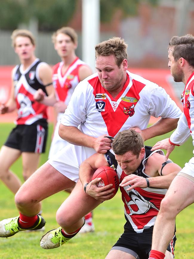 Karingal’s Grant Goodall tackles Shark Gary Carpenter. Picture: Derrick den Hollander