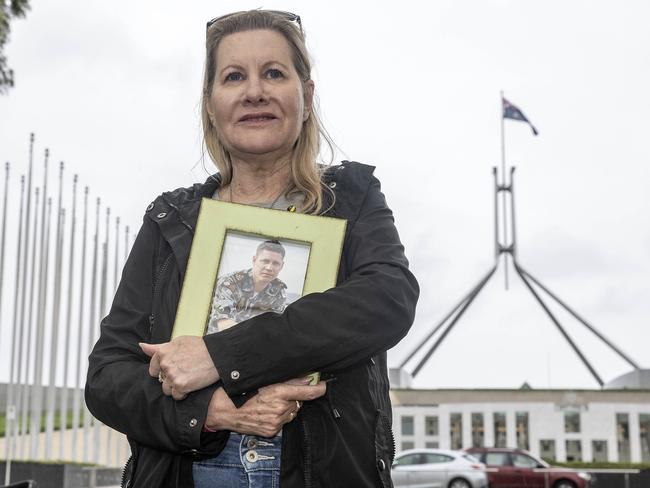 Julie-Ann Finney holds a picture of her son Dave outside Parliament House in Canberra. Picture: NCA NewsWire / Gary Ramage