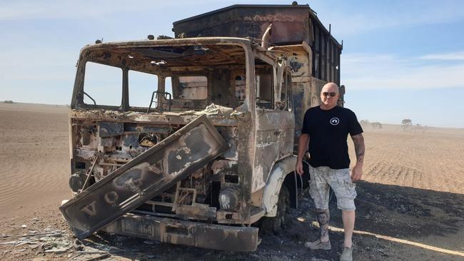 Former Port Adelaide footballer Scott Hodges with a burnt-out truck near Edithburgh. Picture: Kerry Hodges