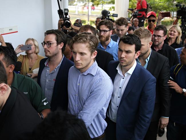 The nine Australian men who were arrested at the Malaysian Grand Prix on Sunday, pictured here arriving at court today lead by James Paver in front. Pictures: Jack Tran
