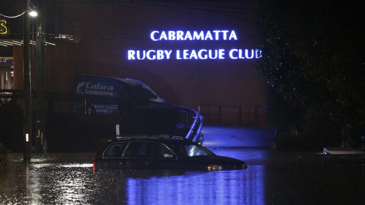 Cars flooded in Church Street, Cabramatta. Picture: John Appleyard