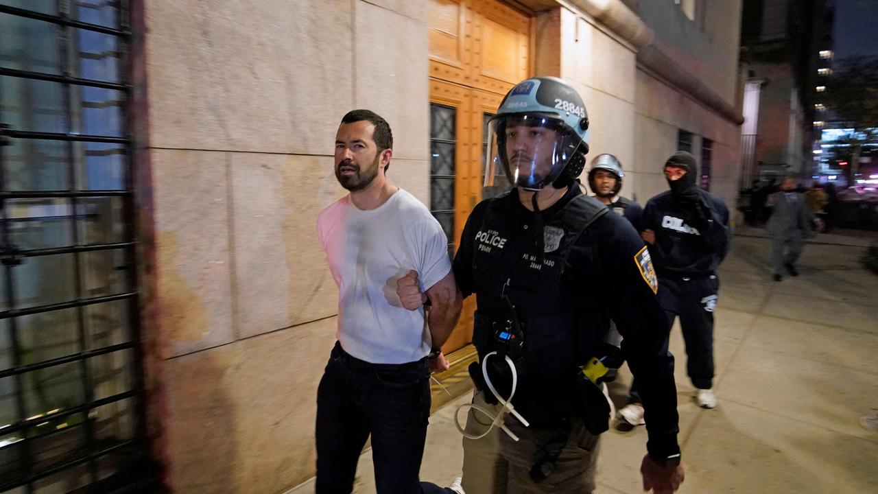 A NYPD officer arrests a student at Columbia University. Picture: TIMOTHY A. CLARY / AFP)
