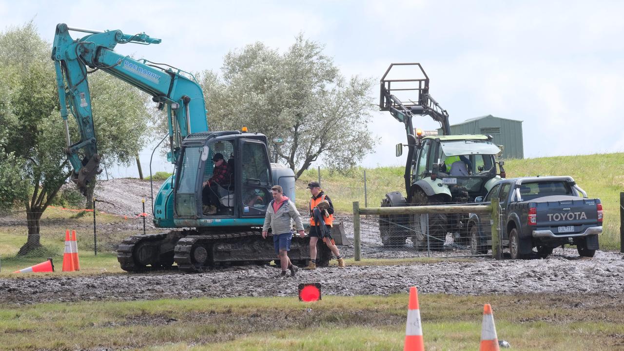 Construction vehicles and tractors were required to remove bogged cars from the Mt Duneed Estate, near Geelong, after rain and heavy winds rocked a music festival on Saturday. Picture: Mark Wilson