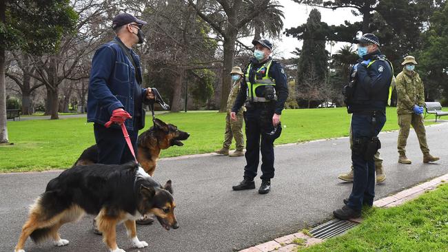 Police officers and soldiers patrol Treasury Gardens. Picture: AFP