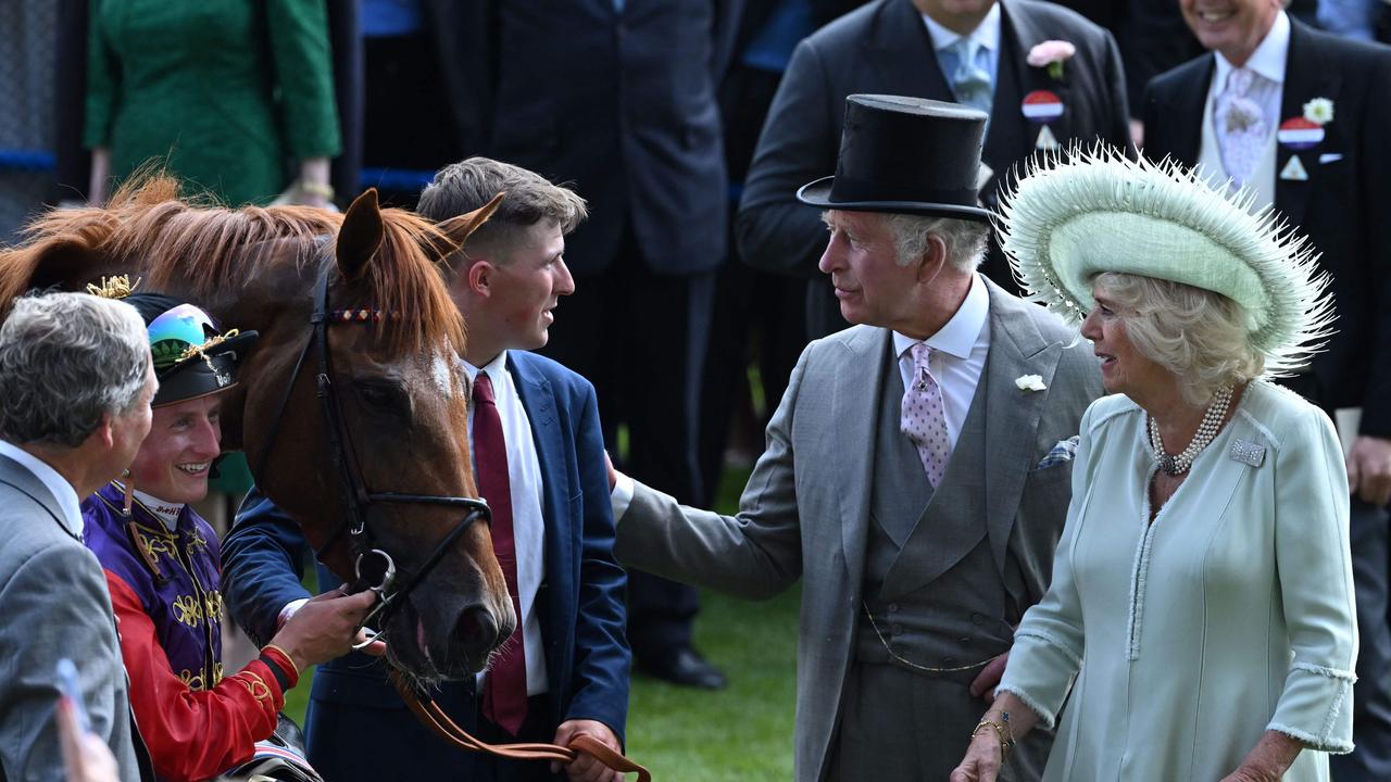 Queen Camilla and King Charles III speak with stable lad Jack Abbey (centre), jockey Tom Marquand and trainer William Haggas in the winner‘s enclosure after their horse, Desert Hero won the King George V Stakes. Picture: Justin Tallis–AFP