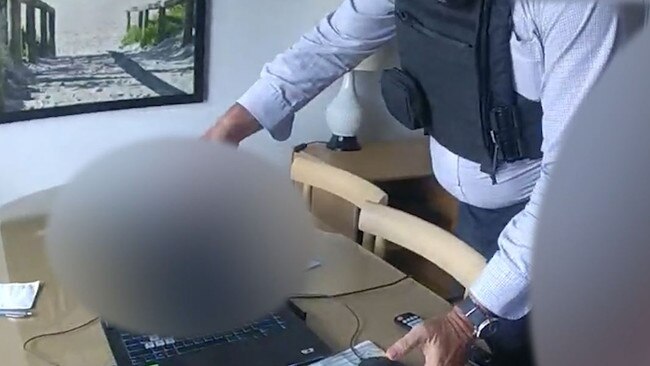 The moment a man accused of sending deep fake images of teachers and students to a Queensland school is arrested in a Surfers Paradise apartment. Picture: Supplied