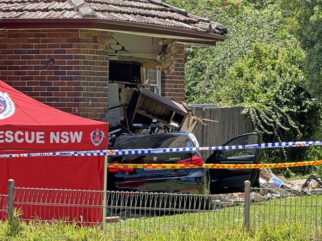 SYDNEY, AUSTRALIA - NewsWire Photos - 13 JANUARY, 2025: A woman has died in a single-vehicle crash in Sydney’s west today. About 10.30am (Monday 13 January 2025), emergency services were called to Punchbowl Road, Belfield, following reports of a crash. Officers attached to Auburn Police Area Command attended and found a vehicle had crashed into a house. The female passenger of the car was trapped for some time before being freed. She was treated at the scene by NSW Ambulance paramedics, however, died at the scene. Picture: NewsWire / Gaye Gerard