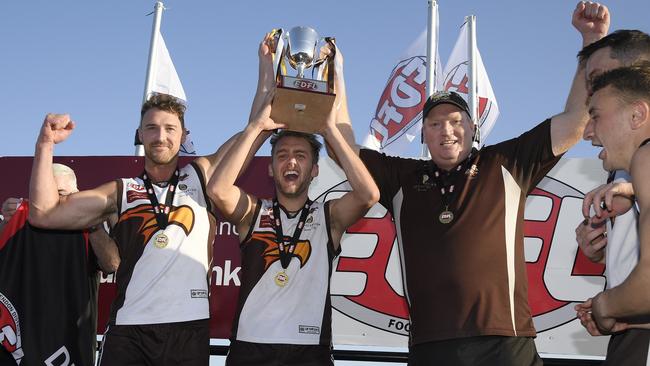 Craigieburn co-captains Christian Mcerlain and Jamie Gorgievski and coach Lance Whitnall lift the EDFL Division 1 premiership cup. Picture: Andy Brownbill