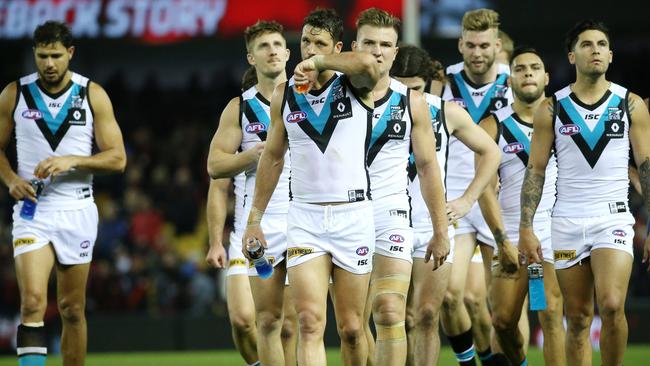 Port Adelaide walk off Etihad Stadium after being smashed by Essendon.