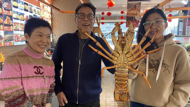 Fan Xubin, centre, and friends selecting an Australian lobster for a Chinese New Year lunch in Beijing. Picture: Will Glasgow