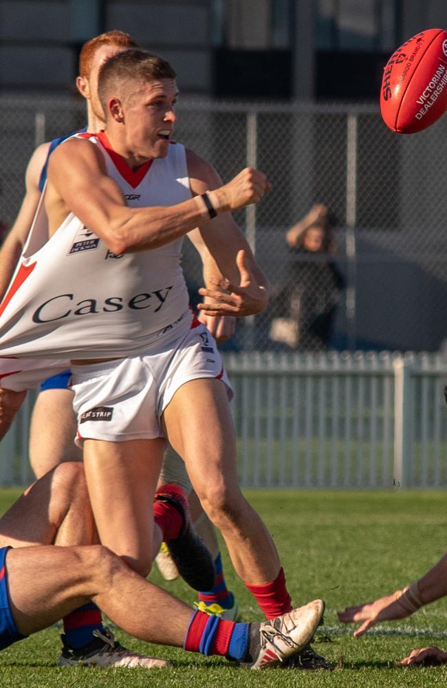 Mitch Lewis pings out a handball for Casey Demons.