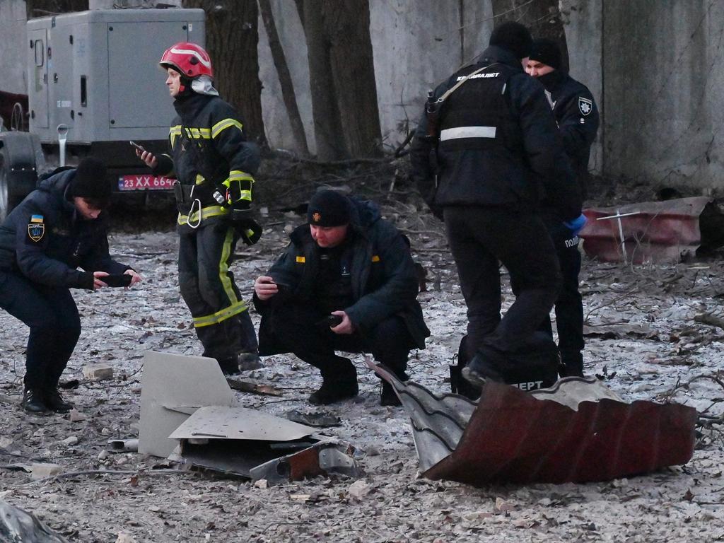 Rescuers and police experts examine remains of a drone following a strike on an administrative building in the Ukrainian capital Kyiv. Picture: AFP