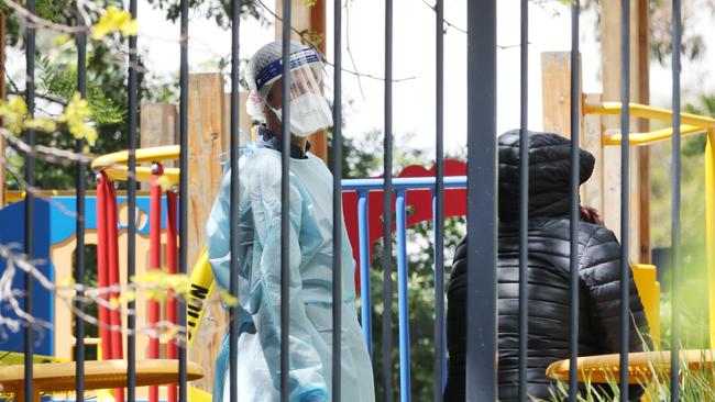 DHHS medical staff at a public housing block in Broadmeadows after a cluster broke out at an Islamic school in Preston. Picture: David Crosling