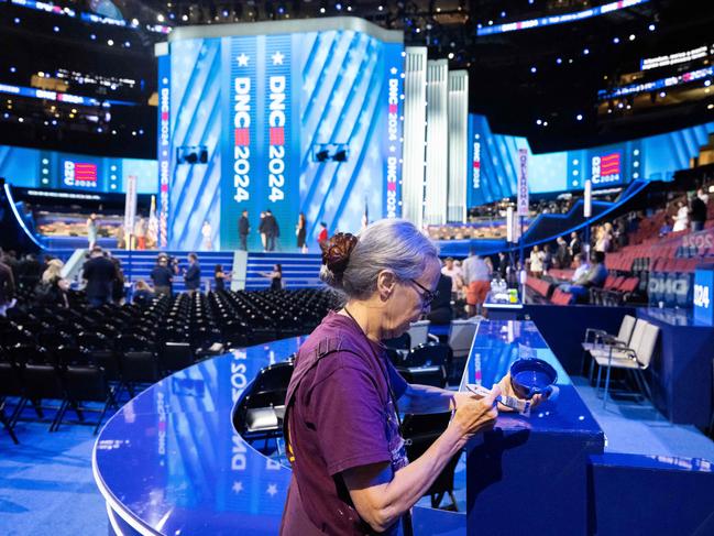 A worker touches up paint as preparations continue one day ahead of the Democratic National Convention. Picture: AFP