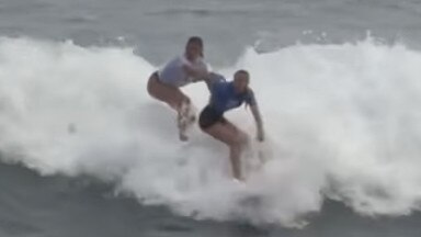 A Portugal surfer (left) tries to push Aussie girl Willoy Hardy (right)  off her board and intimidate her during the world junior surfing event in El Salvador.https://www.instagram.com/p/C6zT1zqvXaZ/