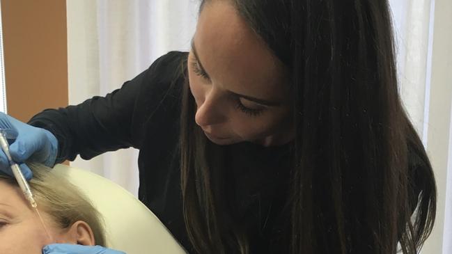 Jennifer Cruz Cole working in a private elective surgery practice as a nurse.