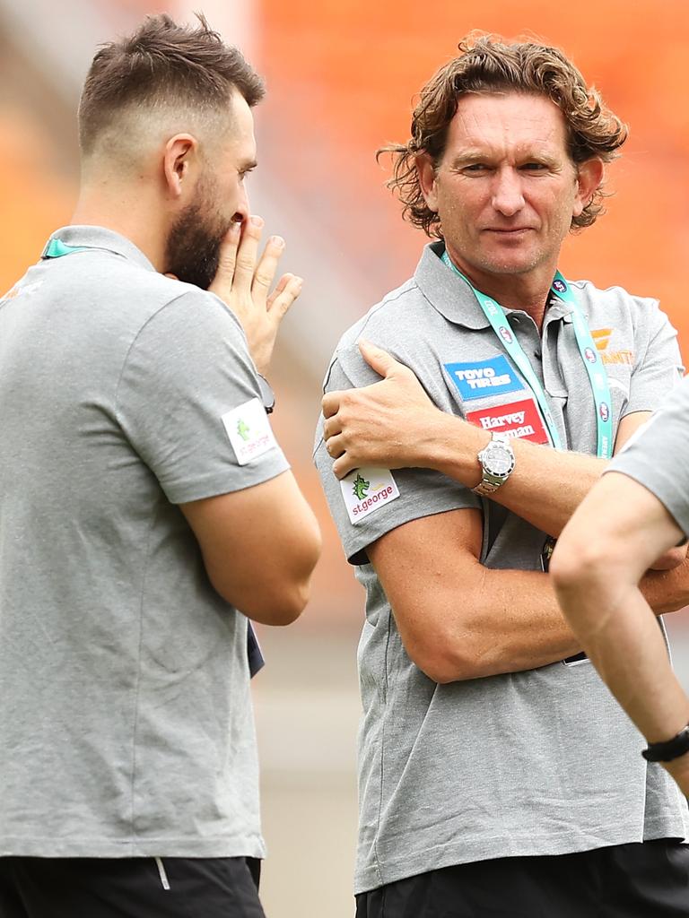 James Hird speaks to other GWS staff before a pre-season game.