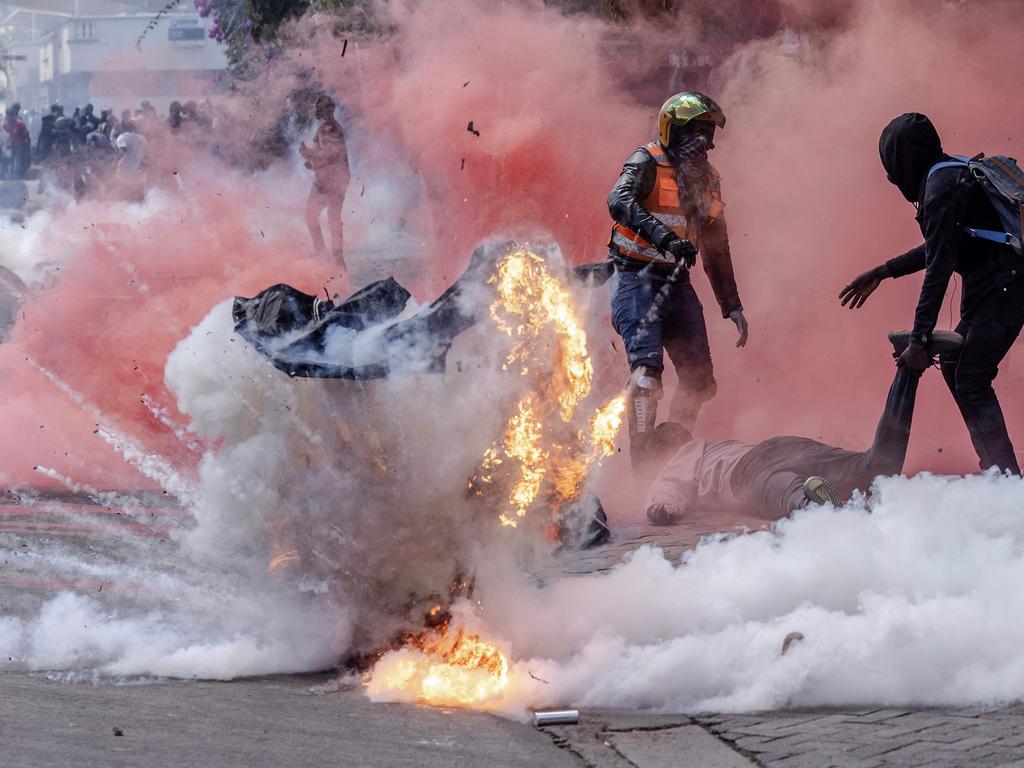 A tear gas canister explodes as protesters try to help injured people outside the Kenya Parliament during a nationwide strike to protest against tax hikes and the Finance Bill 2024, in downtown Nairobi, on June 25, 2024. Demonstrators were angry over proposed tax hikes. Picture: AFP