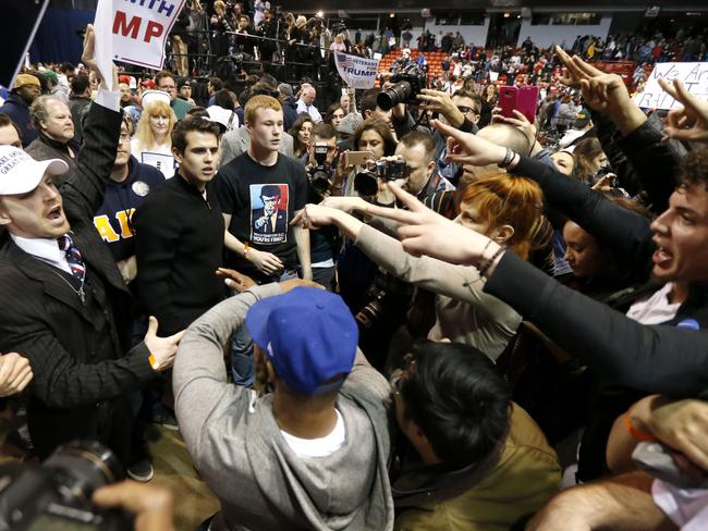 Anger ... Supporters of Republican presidential candidate Donald Trump, left, face off with protesters at a rally on the campus of the University of Illinois-Chicago. Picture: AP