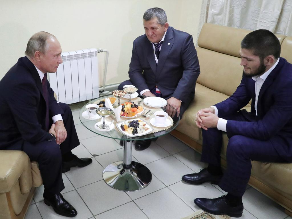 Khabib and his dad with Vladimir Putin.