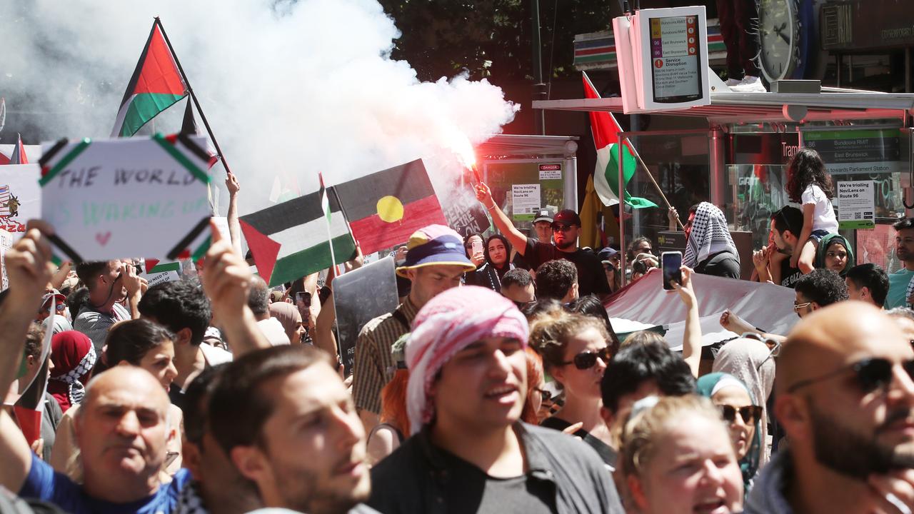 Someone lets off a flare at the pro-Palestine rally in Melbourne’s CBD. Picture: David Crosling