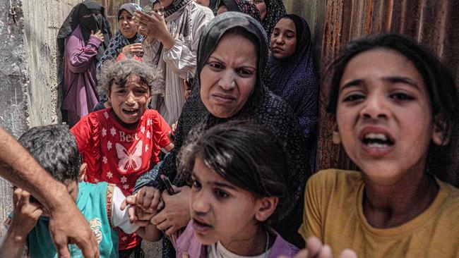 A family flees during an Israeli bombardment of Nuseirat in the central Gaza Strip. Picture: AFP