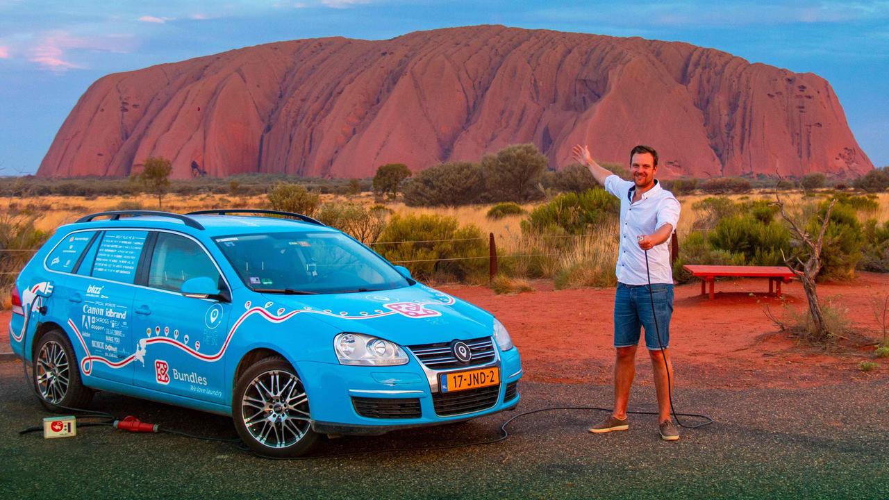 Wiebe Wakker at Uluru in the Northern Territory with his retrofitted station wagon nicknamed ‘The Blue Bandit’ during his round-the-world trip in the electric car. Picture: Wiebe Wakke/AFP